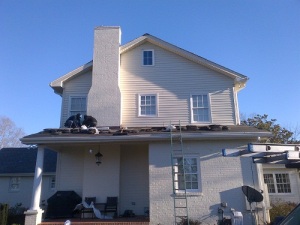Roofing contractors performing roof repairs